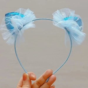 Close-up of light blue sequined cat ear headband with ruffle tulle detail for girls