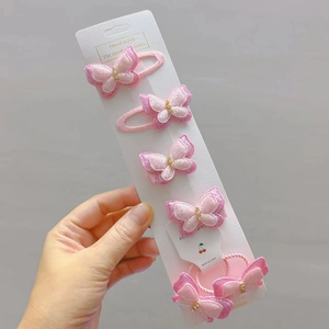 Rosa Glitzer-Schmetterling-Haarspangen und Haargummi-Set auf weißer Karte