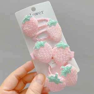 Sparkly pink strawberry hair clip and hair tie set for girls with sequins and leaf detail