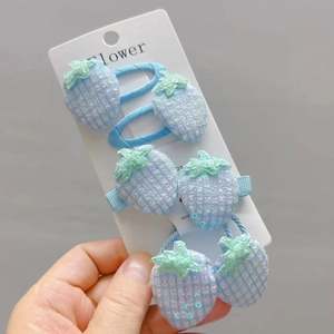 Detail of 6-piece light blue sequin strawberry hair clips and elastics set for girls