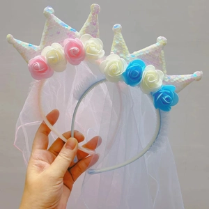 Detail of sequin crown headbands with floral accents and long veils for girls