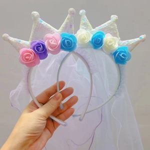 Detail of white sequin crown headband with colorful faux roses and bridal veil for girls