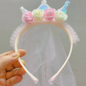 Detail of sequin crown headband with pink roses and white mesh veil for girls