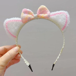 Pink plush cat ear headband for girls with sequined bow and white faux fur detail