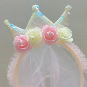 Detail of sequins crown headband with floral roses and dreamy long white tulle veil