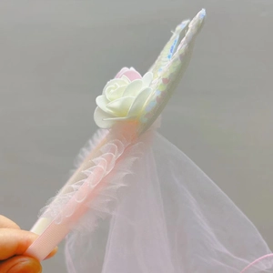 Detailed macro view of white fabric rose and sparkling sequins on pink mesh headband