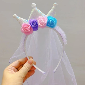 Detail of glitter crown headband with colorful silk roses and long white mesh veil