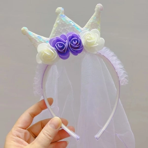 Close-up of a sequin crown headband with purple mesh veil and delicate roses