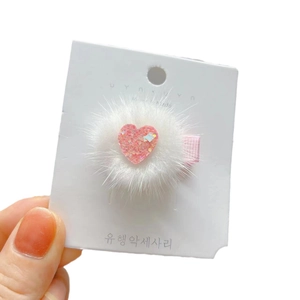 Sparkly pink heart hair clip with white faux mink fur ball accessory for women