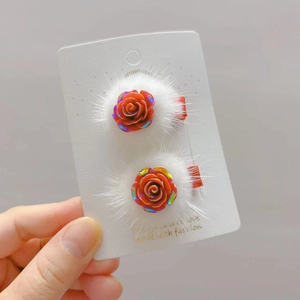 Détail de pinces à cheveux rose rouge en résine avec fausse fourrure blanche douce