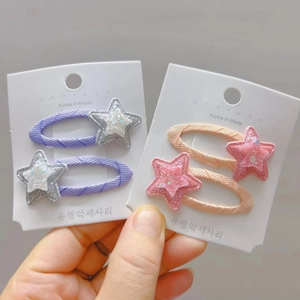 Detail of colorful star hair clips and woven barrettes on display cards for kids
