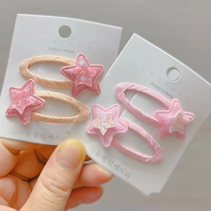 Detail of woven star hair clips featuring shimmering glitter and candy colors for girls