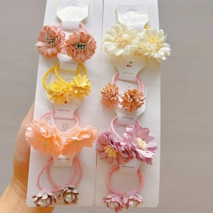 Détail d'élastiques à fleurs en tissu coloré avec perles sur cartes pour enfants
