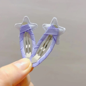 Detail of star hair clips in light purple fabric with soft white felt tips for kids