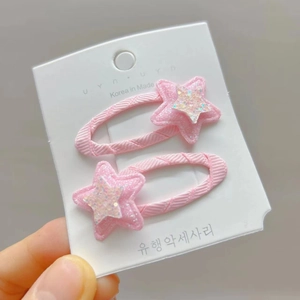 Pink star-shaped hair clips for girls with glitter accents and soft woven texture