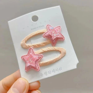 Detail of pink glitter star hair clips with soft fabric base for girls and kids