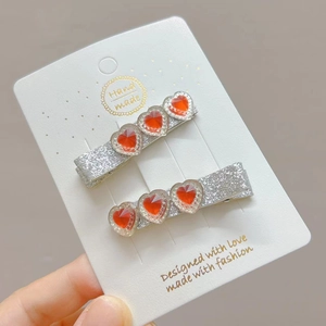 Sparkling silver glitter hair clips with three red heart crystals for women and girls