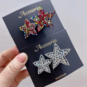 Sparkling star-shaped hair clips set with colorful and clear rhinestones on display card