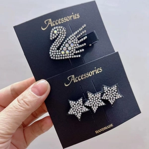 Sparkling swan and stars rhinestone hair clips on professional display card