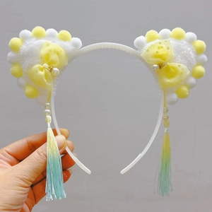 Detail of Chinese style cat ear headband with pearl bow and long silk gradient tassels
