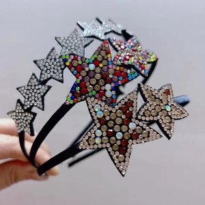 Close-up of fabric-wrapped headband featuring sparkling crystal star decorations