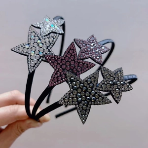 Detailed view of three rhinestone star headbands in silver, pink, and grey metal frames