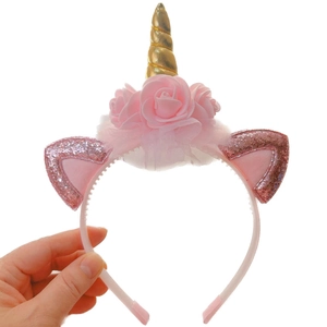 Unicorn headband for girls featuring golden horn, pink roses, and glitter ears on white background