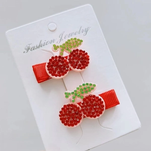 Sparkling cherry hair clips set with red rhinestones and green leaf design for girls