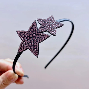Detailed view of non-slip hairband featuring sparkling purple rhinestone double stars