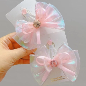 Detail of pink iridescent bow hair clips with organza and sequins on display cards