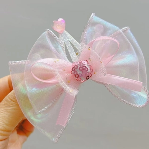Detailed view of a pink mermaid-style hair clip featuring organza bows and sequin ball