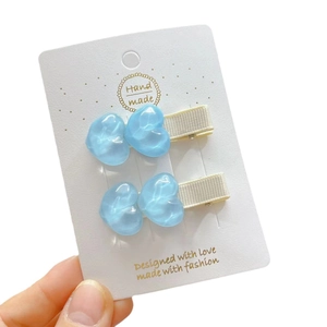 Coppia di fermagli per capelli a cuore blu gelatina con texture ondulata e base beige