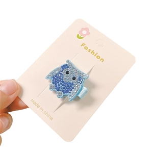 Sparkly blue owl hair clip for kids featuring glitter rhinestones on display card