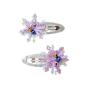 Set of two purple snowflake hair clips with silver glitter and colorful small bells