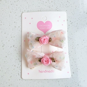 Floral lace bow hair clips with rose detail for girls and women in soft pink