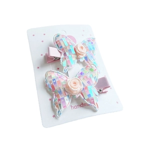 Sequin butterfly hair clips set with pink fabric roses on white display card