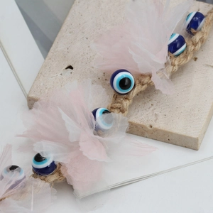 Blue glass evil eye wall hanging decor with woven rope and delicate mesh flower accents