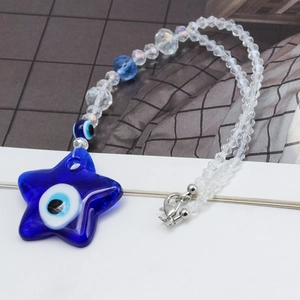 Detailed close-up of dark blue star evil eye charm with beaded glass chain and metal clasp