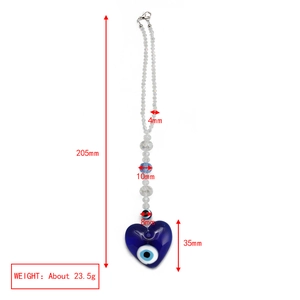 Detail view of evil eye glass heart charm and crystal beads with dimensions