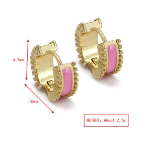 Detailed view of gold C-shape hoop earrings with pink enamel and vertical ribbed texture