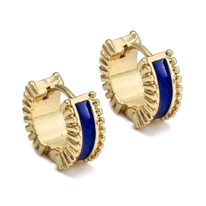 Close-up of gold C-shaped earrings with blue enamel and engraved vintage radial texture