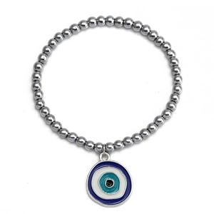Detail of beaded hematite bracelet featuring a blue evil eye charm with metallic finish