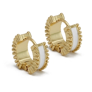 Detailed macro view of gold-plated C-shaped huggie earrings with white enamel inlay