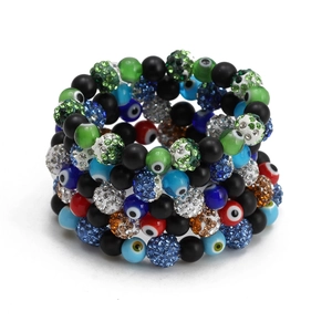 Macro detail of multi-layered evil eye beaded bracelets with colorful rhinestones