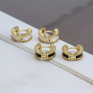 Retro C-shape gold huggie earrings with pink enamel and evil eye details in a set