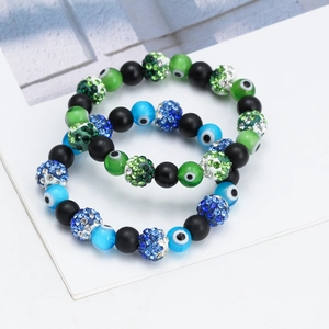 Close-up of black beaded Evil Eye bracelets with sparkling rhinestones and colorful details