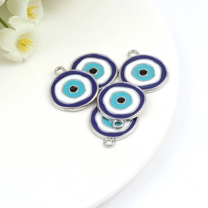Macro detail of blue evil eye charms with silver metal borders for DIY jewelry making