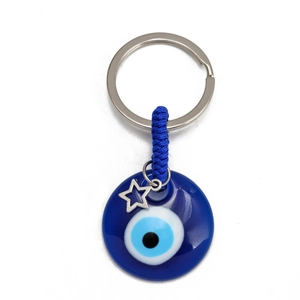Detailed macro view of the blue Evil Eye glass pendant with a silver star charm