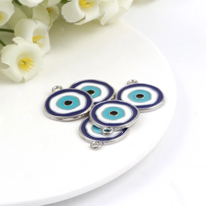 Detailed view of evil eye charms for jewelry making arranged on a decorative plate