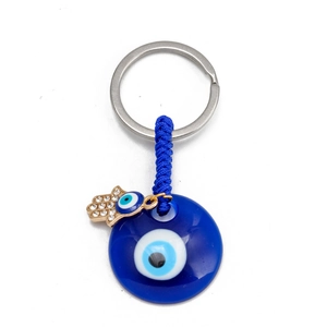 Detailed close-up of blue evil eye keychain with Hamsa hand and sparkling crystal accents